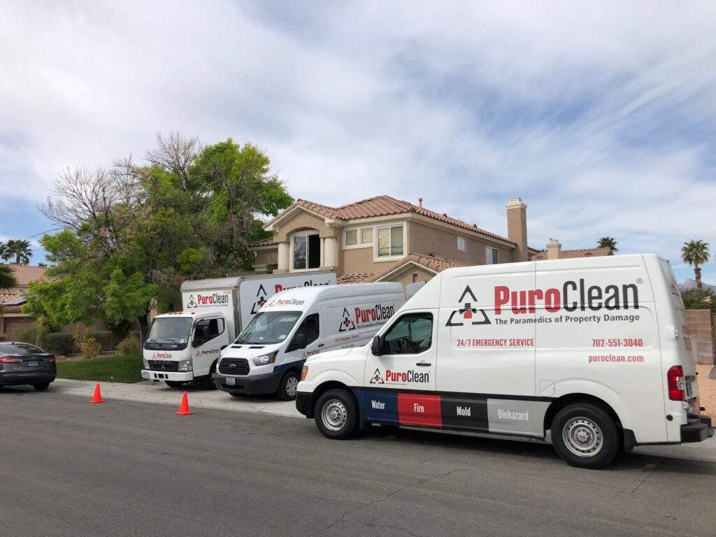 PuroClean vehicles parked in front of a resident home 