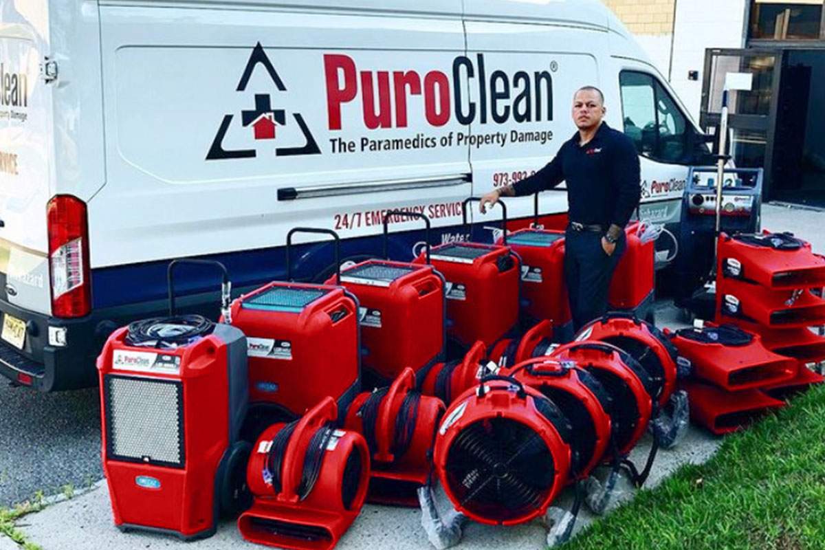 PuroClean fan with equipment surrounding it