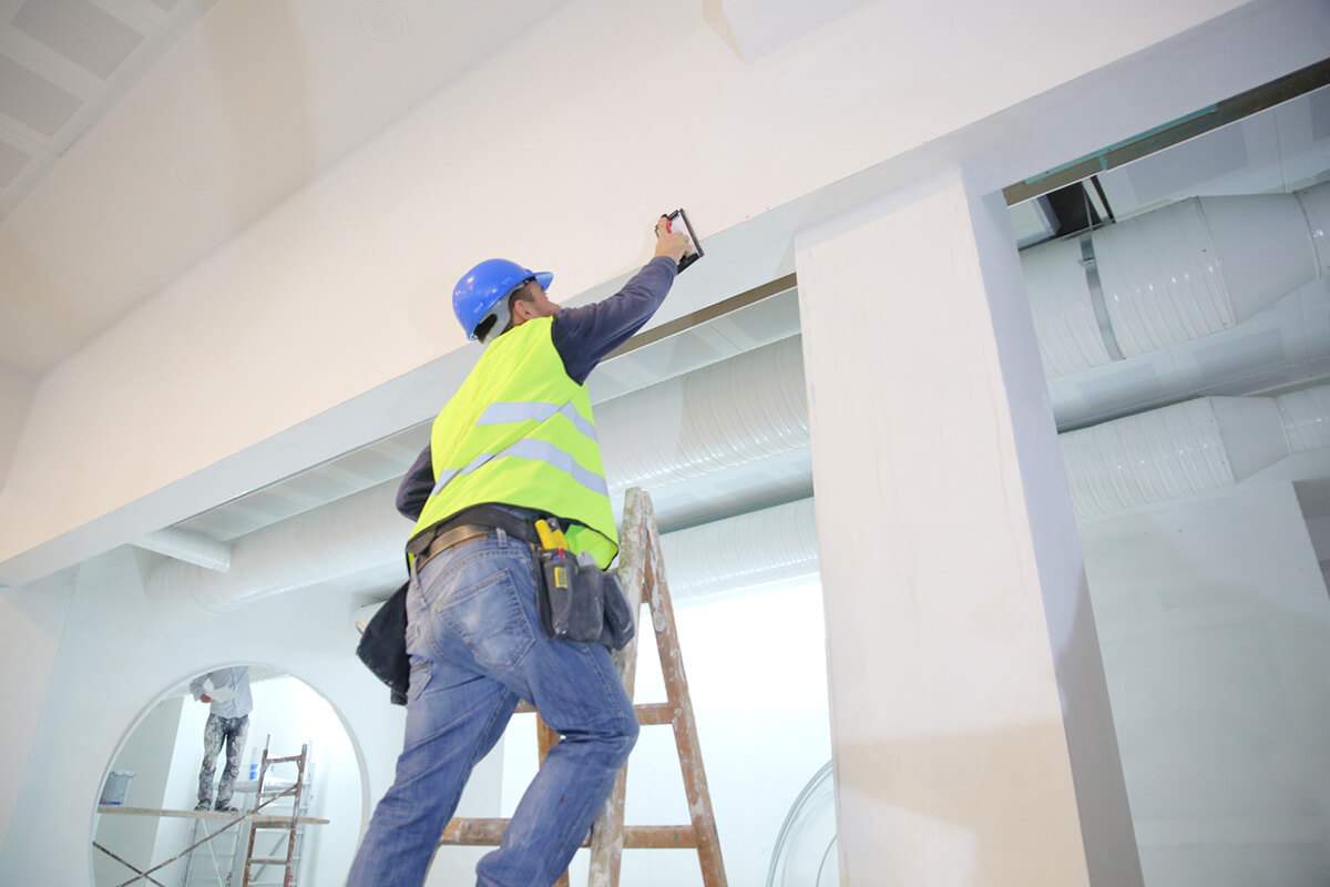 PuroClean employee fixing ceiling