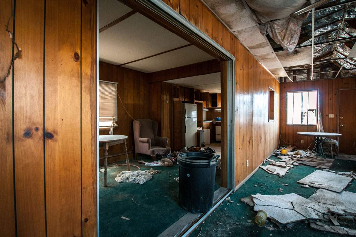 a room with damage and ceiling falling