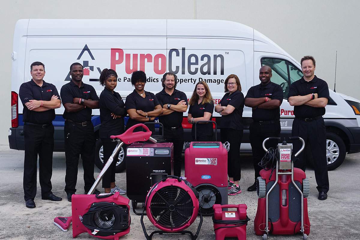 PuroClean team in front of a company van