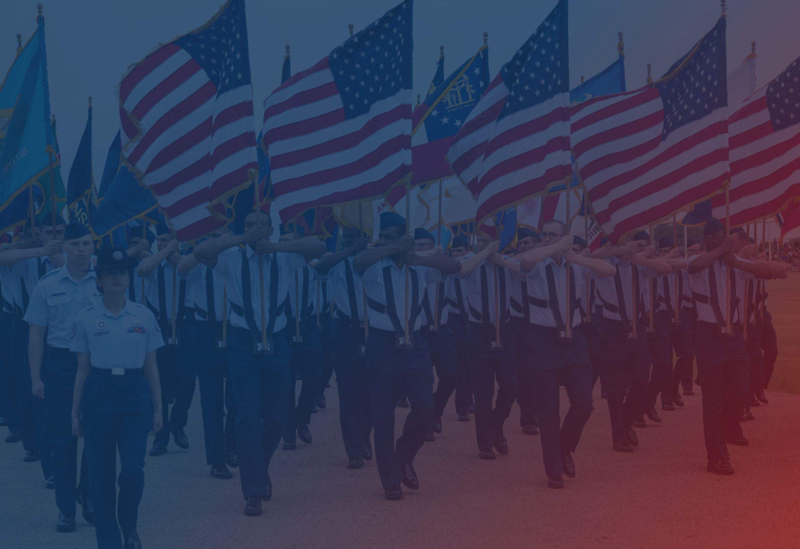 A parade of military veterans carrying American flags