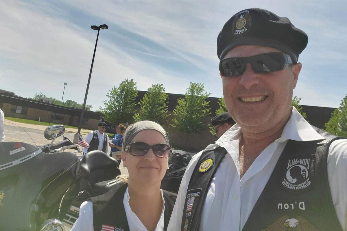 man and woman in motorcycle vest