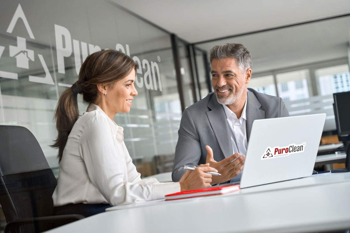 man and woman on a laptop