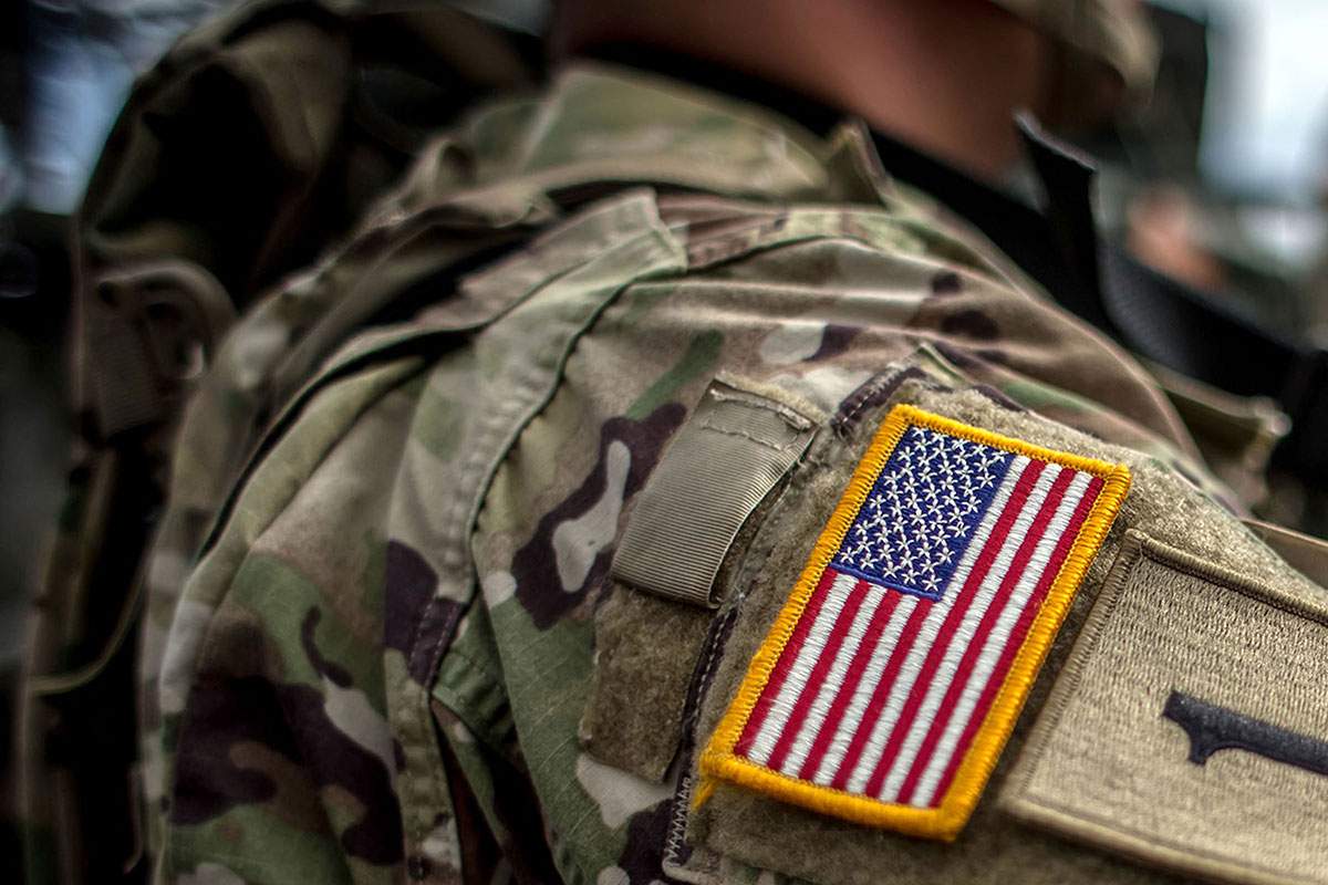 Military serviceman with American flag patch on fatigues