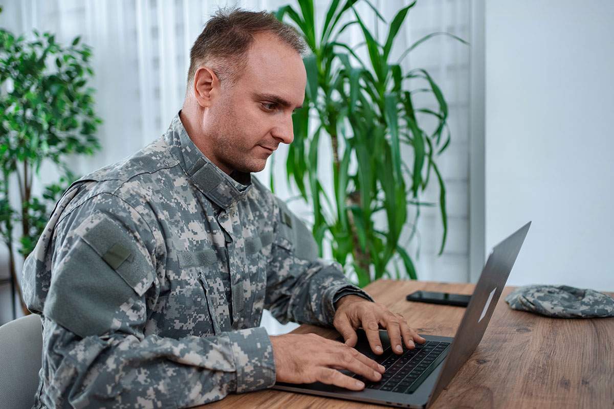 Military personnel reviews business leadership online