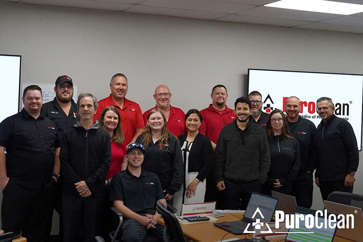 A group of people smiling and posing together for a photo.