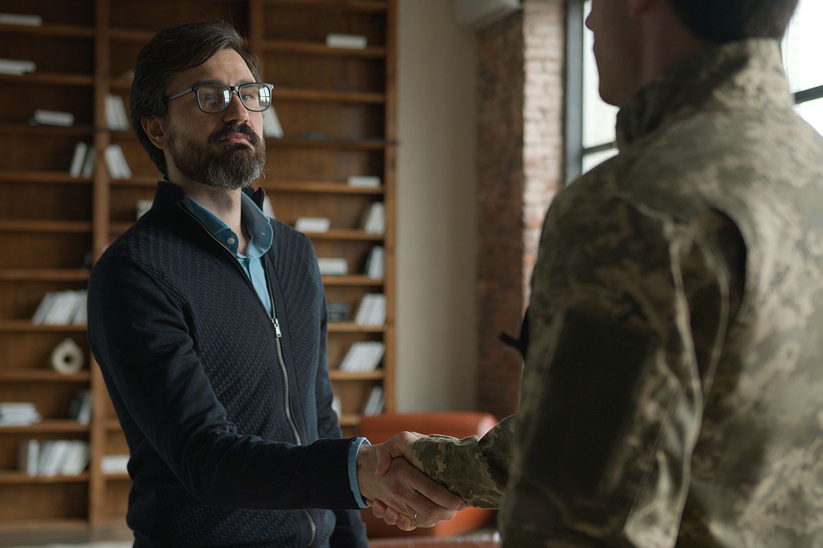 Civilian and military veteran shake hands