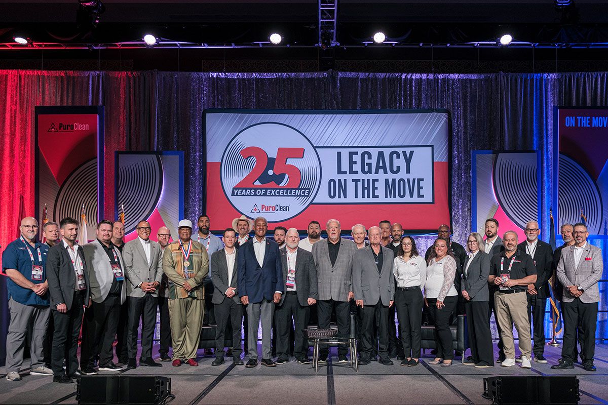 Members of the PuroVet fireside chat group pose on stage.