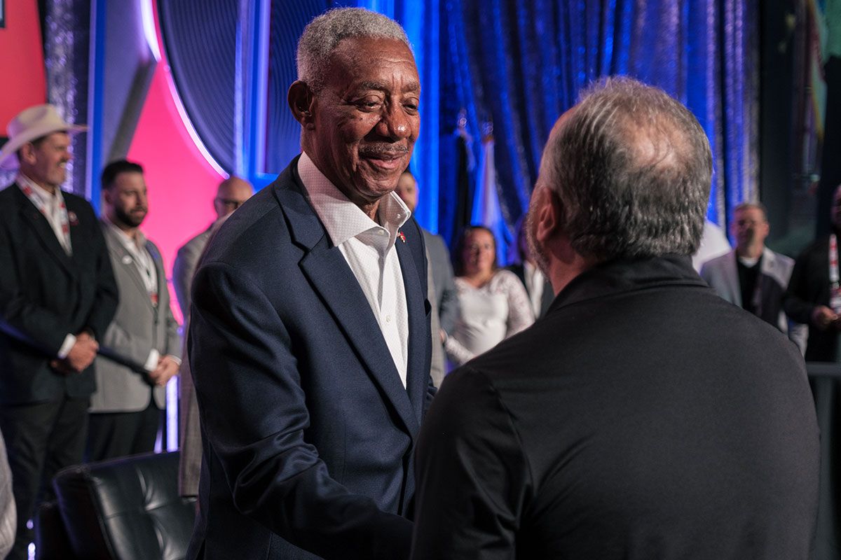 A Fireside Chat attendee shakes hands with one of the speakers