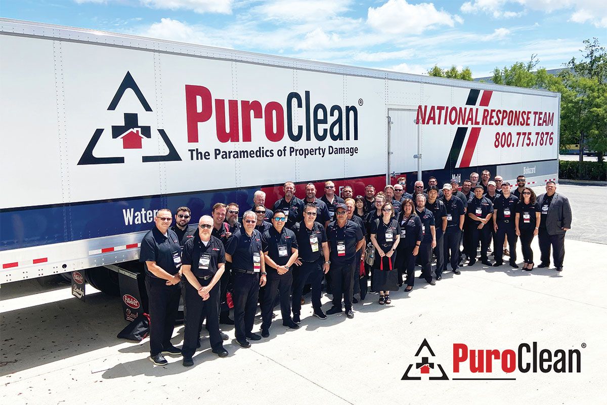 PuroClean 18 wheeler and a group of people