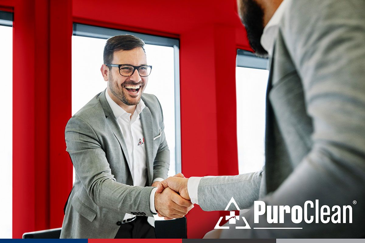 Man shaking another mans hand
